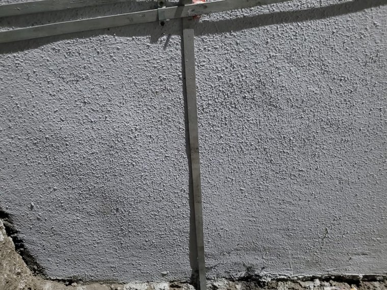 GI strip conductor run along building wall