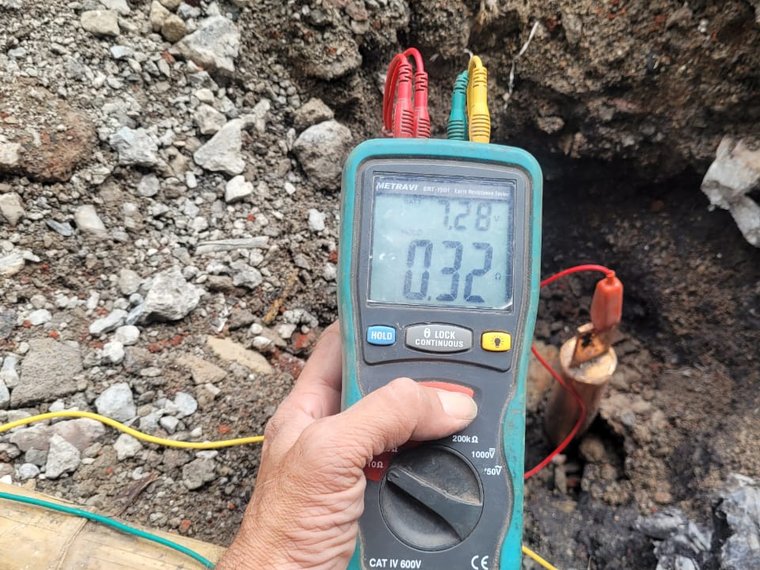 Technician measuring earth resistance on site